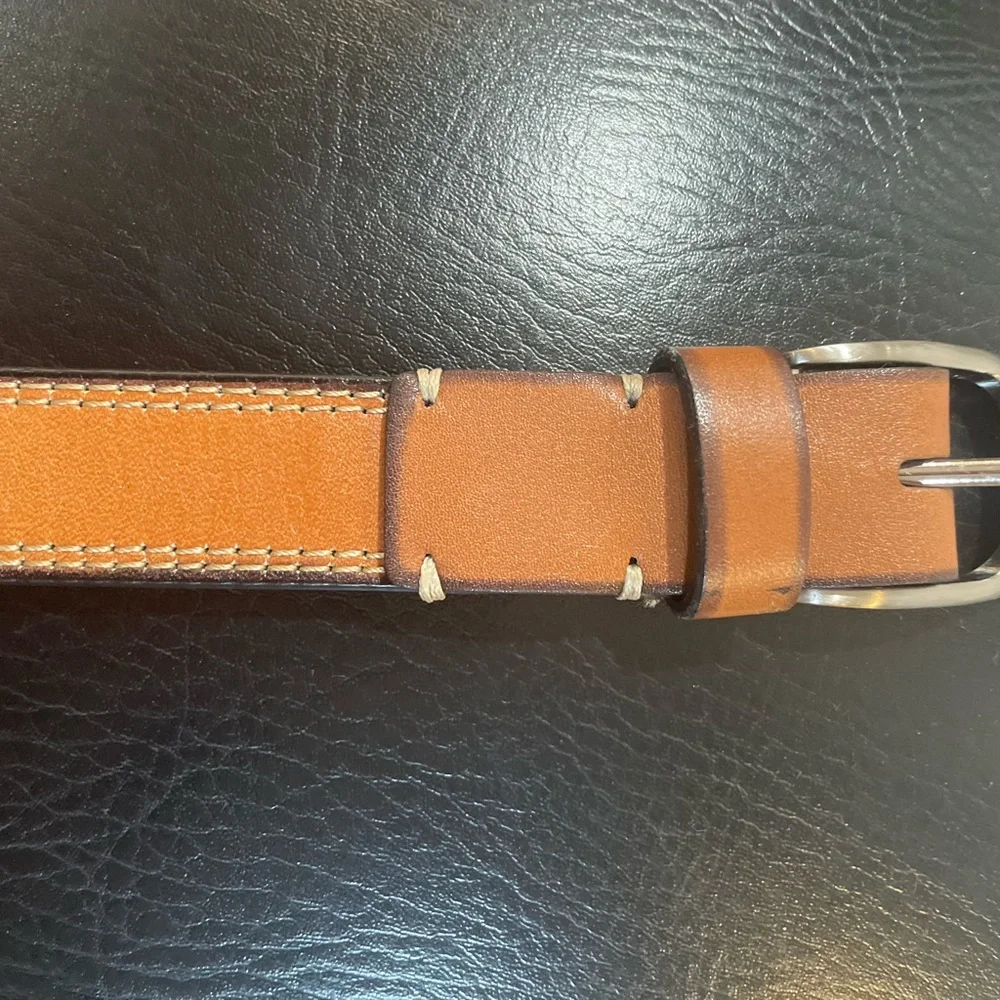 NWOT Genuine leather belt. 31” of leather end to end not including buckle.26/28